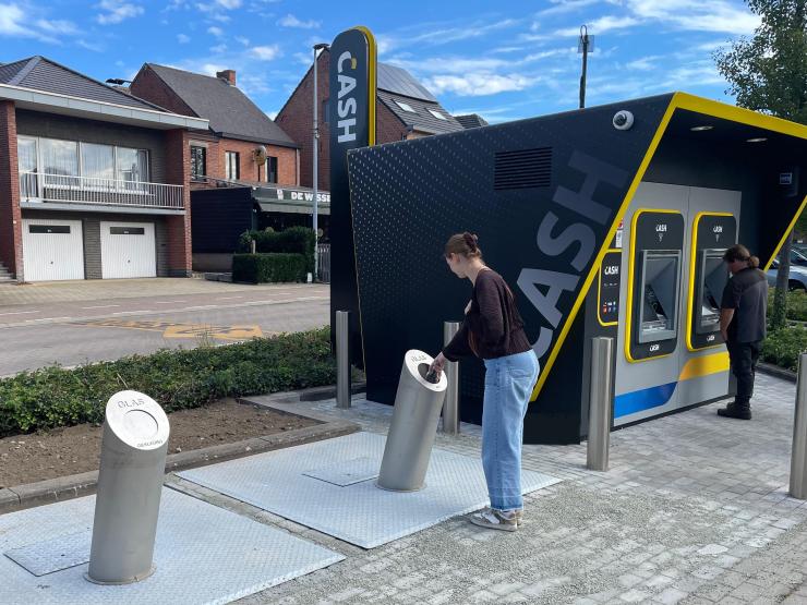 Iemand werpt glas in de ondergrondse glascontainers in Werchter.